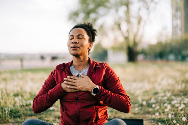 Person standing peacefully by the water, embracing personal growth and well-being